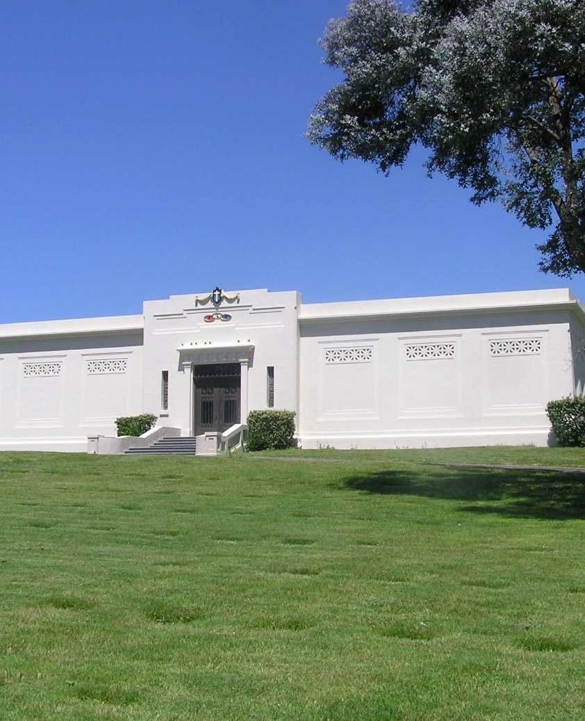 The historic mausoleum at Santa Rosa Memorial Park, a stately white building set on green lawns